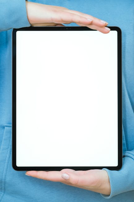 Close-up of a person holding a blank digital tablet with ample copyspace.